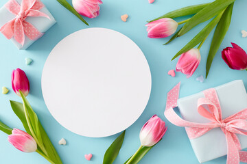 Top view composition of white circle gift boxes with bows hearts baubles pink tulips flowers on isolated pastel blue background with blank space. Happy Mother's Day mood concept