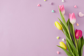 Mother's Day celebration idea. Top view composition of bouquet of pink yellow tulips and colorful...