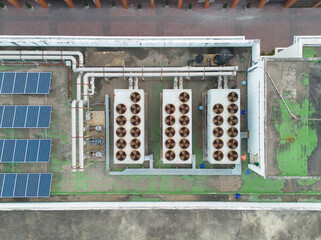 Aerial top view of industry factory, ventilation fan cooling motorized stainless steel power units,...