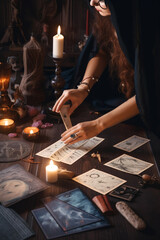 Fototapeta premium Witch woman using tarot cards for love spelling, divination and fortune telling. Generative AI
