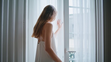 Fototapeta na wymiar Relaxed woman looking window morning indoors closeup. Lady spending lazy weekend
