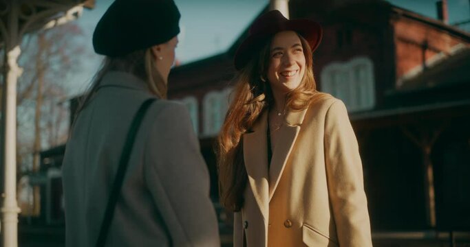 Two Women Walking at Railway Station