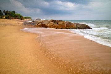 scenic view over the popular Kirinda Beach Sri Lanka with stormy sea in the evening