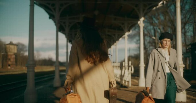 Two Women Walking at Railway Station