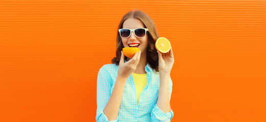 Summer portrait of happy smiling young woman with slices of fresh orange fruits on background
