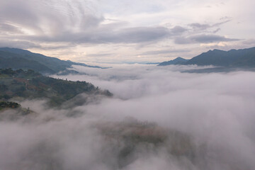 Aerial top view of fresh paddy rice terraces, green agricultural fields in countryside or rural area of Mu Cang Chai, mountain hills valley in Asia, Vietnam. Nature landscape background.