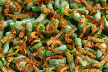 textured green bean casserole with crispy fried shallots and cream sauce.