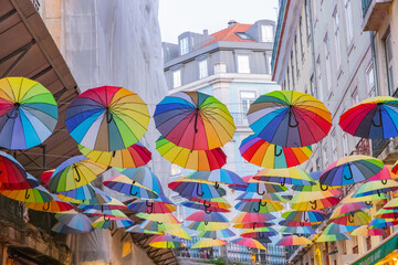 Fototapeta na wymiar Colorful umbrellas above a walking street in Lisbon.