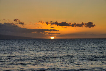 Fototapeta na wymiar Golden sunset over a calm Maui ocean.