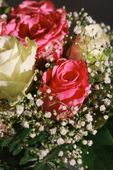 close up of pink and white roses flowers bouquet with greens. 