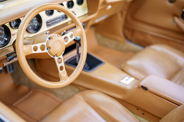 Vintage car interior photo focus on steering wheel