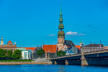 the old town of riga including saint peters church viewed over daugava river, Latvia.