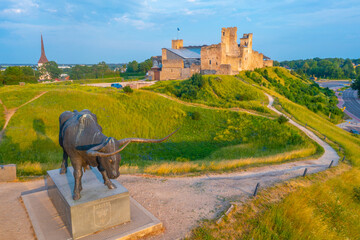 Aurochs Statue with Rakvere castle in background, Estonia