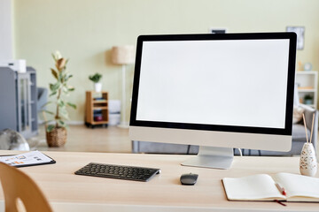 Background image of blank computer screen mockup at workplace desk in home office setting, copy space