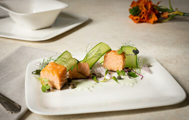 Plated Smoked Salmon Cubes with Sliced Cucumber and Dill