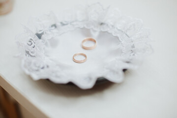 Fototapeta na wymiar Wedding ceremony, two gold wedding rings on a bowl