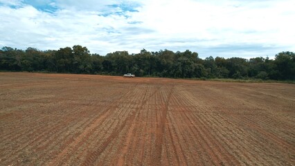 Farmer driving pickup truck in soy farm