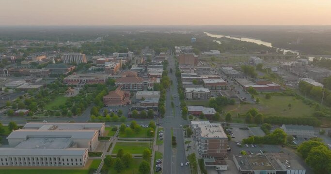 Aerial Beautiful View Of Buildings On City Landscape With River, Drone Flying Downwards During Sunset - Tuscaloosa, Alabama