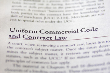 uniform commercial code UCC and contract law printed in text on page as visual aid or business law...