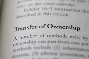 Fototapeta premium transfer of ownership printed in text on page as visual aid or business law reference