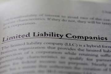 Limited liability company LLC printed in text on page as visual aid or business law reference - obrazy, fototapety, plakaty