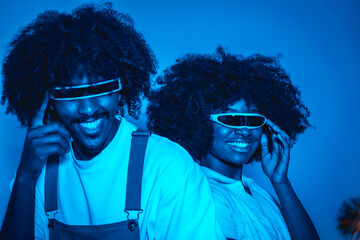 Young african american couple smiling in futuristic glasses, modern future concept, science entertainment, digital technology