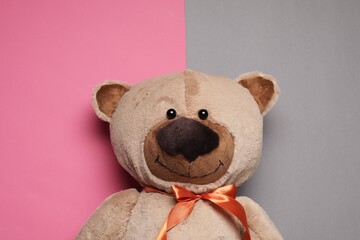 Cute teddy bear on color background, top view
