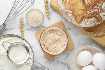 Flat lay composition with sourdough on white marble table