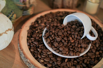 Roasted coffee beans in white cup. retro style toned, copy space. Background and texture of roasted coffee beans