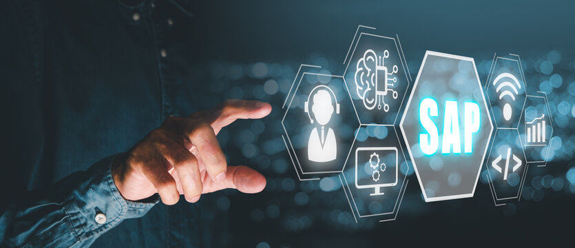 SAP - Business process automation software and management software (SAP), Person hand touching SAP icon on virtual screen with blue bokeh background.
