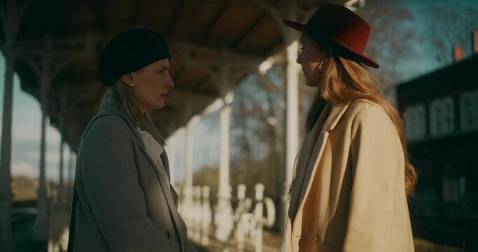 Two Women Walking at Railway Station