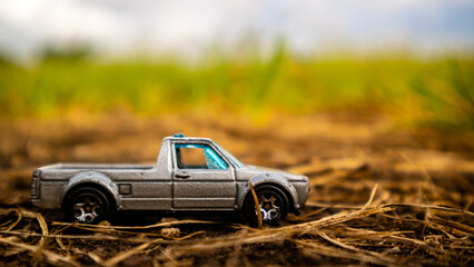 South Minahasa, Indonesia : February 2023, toy car on green grass