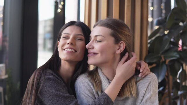 Homosexual Gay Female Couple hugging and Kissing while in a cafe shop, lgbt and love concept