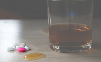 Close up of drugs on floor.Drugs and Alcohol is a toxin that can damage the liver, brain, and other organs over time. Excessive consumption can lead to addiction, health problems, and even death.