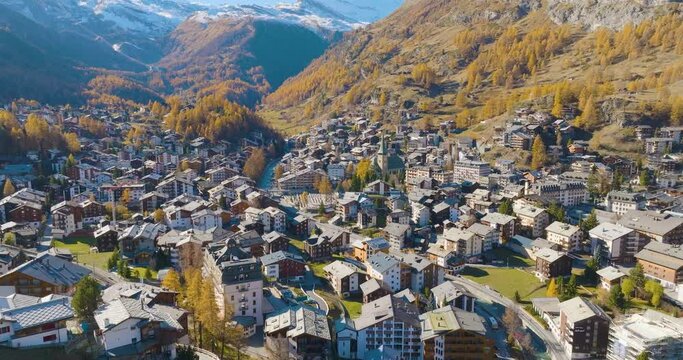 Aerial drone of Zermatt city Valley famous ski resort and iconic Matterhorn peak in autumn season with beautiful landscape in Canton Valais, Switzerland. Swiss alps most popular travel destination.