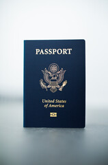 Close-up of a US passport with immigration, visa, citizenship, and travel paperwork on a wooden table