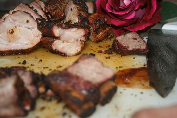 Tasty barrel roast pork decorated with red roses
