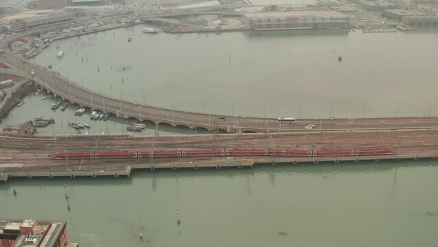 Slow pan up aerial shot of Italian high speed train arriving at Venice Santa Lucia station