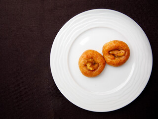 Turkish Dessert Sekerpare on white plate. Small cakes with Almond and Sherbet Syrup, top view