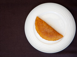 Traditional Turkish Dessert Tas Kadayif on white plate close up top view.