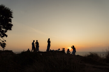 group of children playing in the sunset