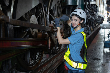 Obraz na płótnie Canvas Portrait of Engineer train Inspect the train's diesel engine, railway track in depot of train 