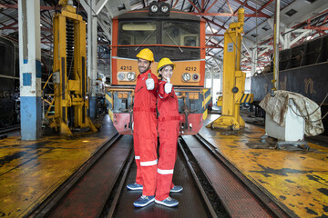 Engineer train Inspect the train's diesel engine, railway track in depot of train
