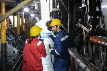 Engineer train Inspect the train's diesel engine, railway track in depot of train
