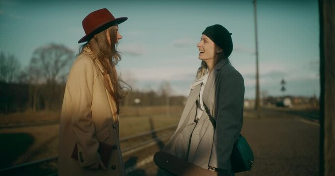 Two Women Talking at Railway Station