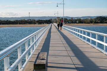 Long jetty on a sunny cloudless day