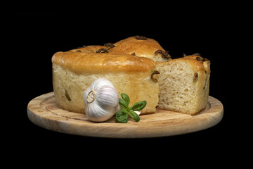 Focaccia bread with olives on black background