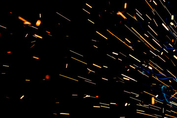 Close up view and background of the gas metal arc welding (GMAW) process with sparks, light, bokeh effect and smoke.