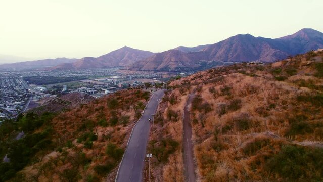 Aerial shot of the viewpoint at Los Gemelos with cyclists climbing and descending in Santiago