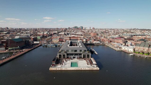 Historic City Pier in Baltimore, MD. Long 4K drone shot, moving in on classic "City Pier, Broadway" sign.